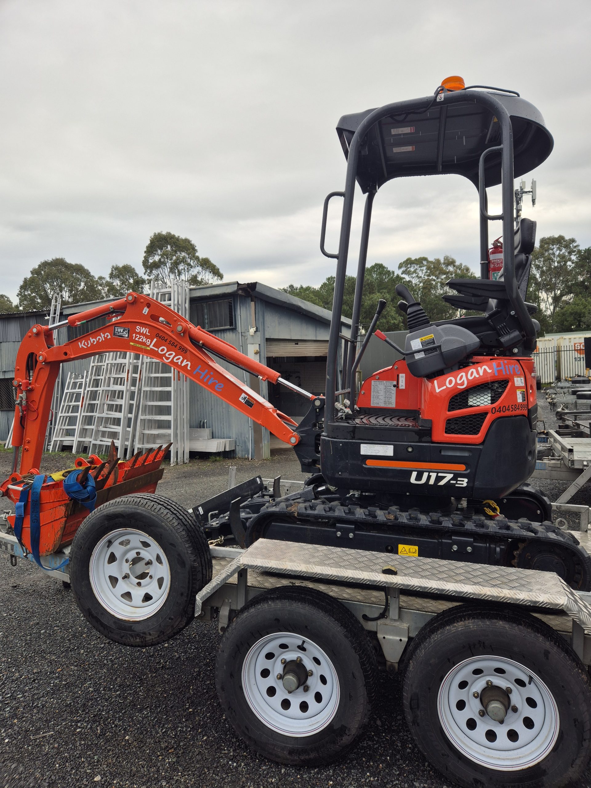 1.7 ton mini excavator for hire in Logan, loaded on a plant trailer